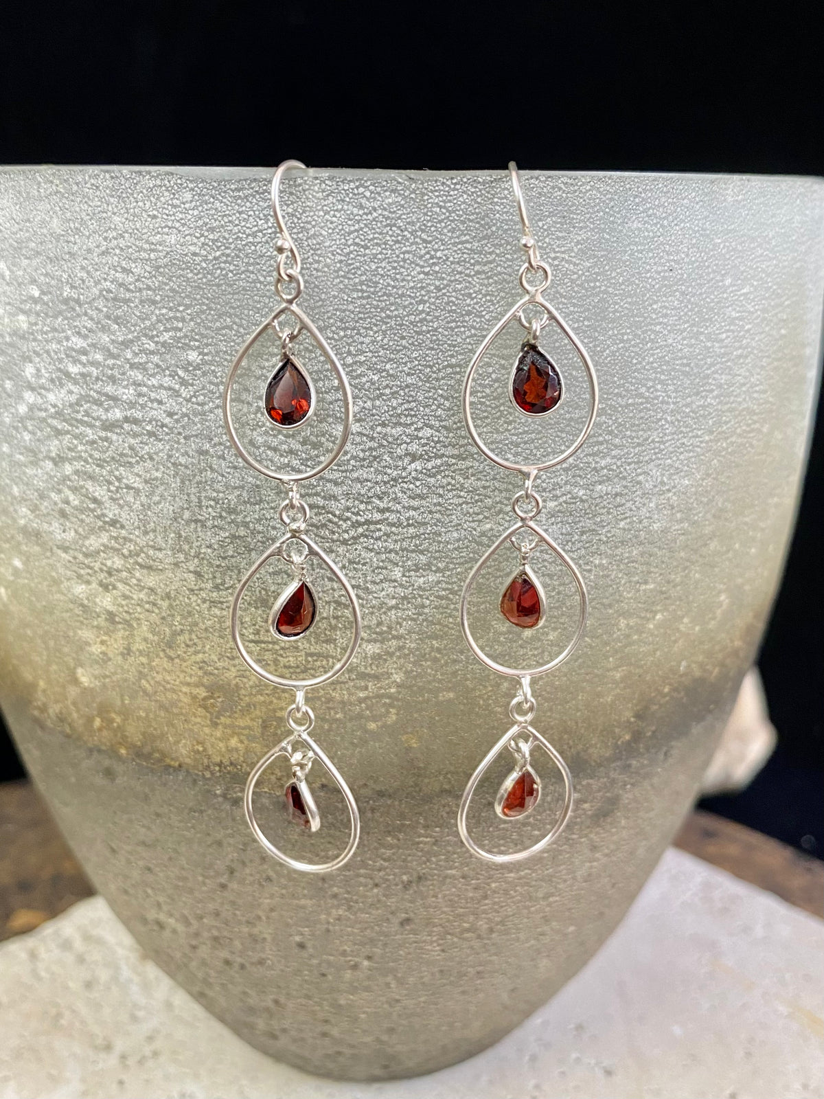 Beautiful garnet earrings featuring a sterling silver chandelier mount with three perfect facet cut teardrop garnets of superb quality. Light and easy to wear.  Measurements: 7 cm including hook 