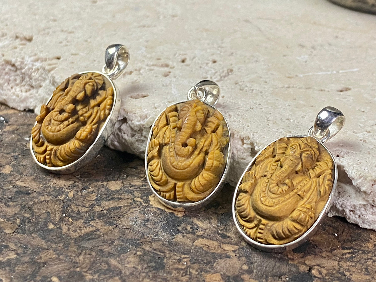 Hand carved Ganesh pendants, tigers eye with sterling silver mount and bail.  Dimensions 3.7 x 1.7 x 0.7 cm