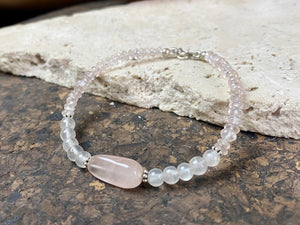 A simple bracelet made from rose quartz, finished with sterling silver detailing and clasp.  Measurements: 19 cm length, centre rose quarrz stone 2 cm length