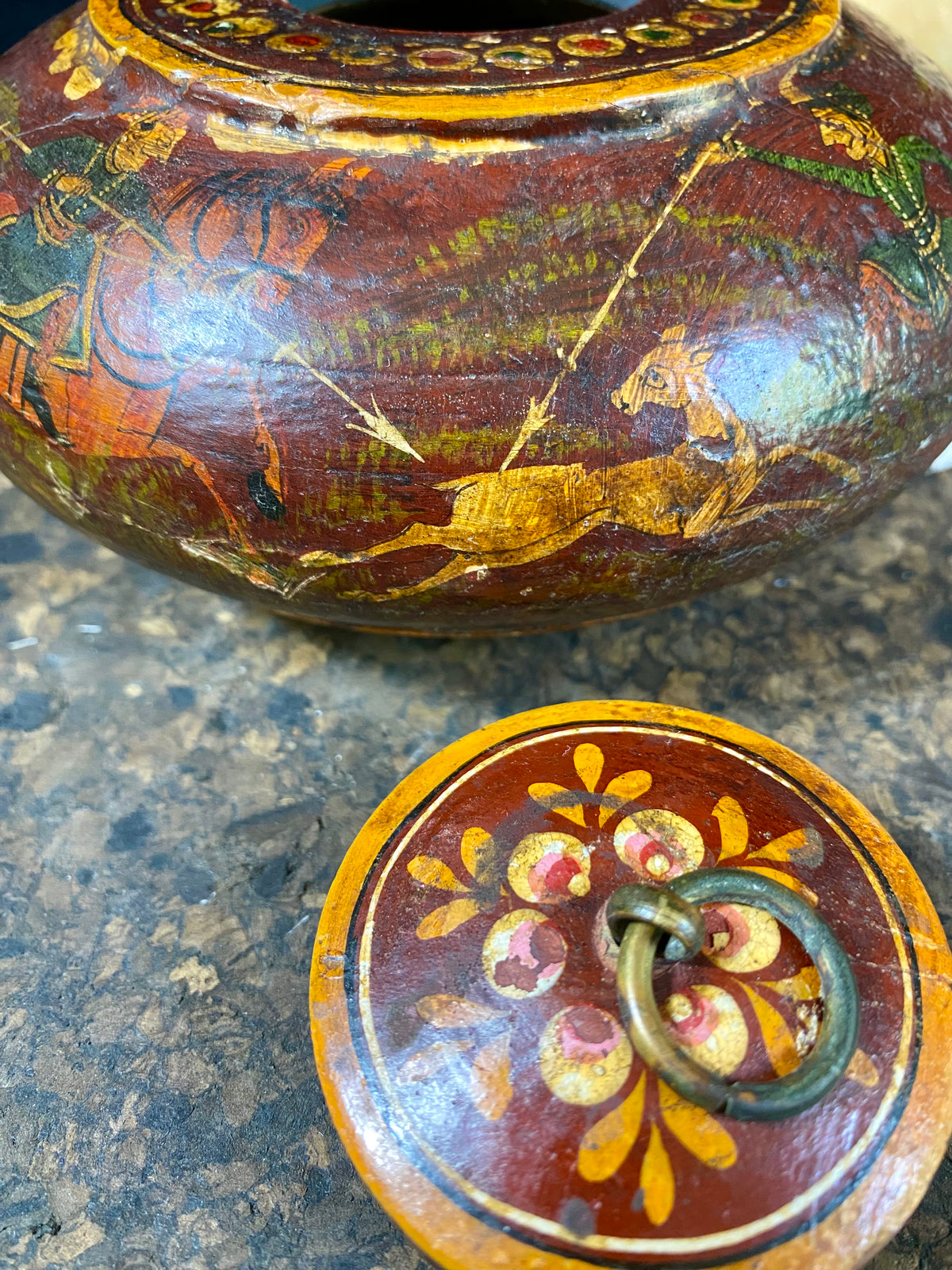 A beautiful low oval lidded bowl or box, traditionally called an opium pot because of its shape. Crafted from wood, then hand painted with hunting scenes. Hand made in Rajasthan, India. Measurements: diameter 14.5 cm, height 7 cm.