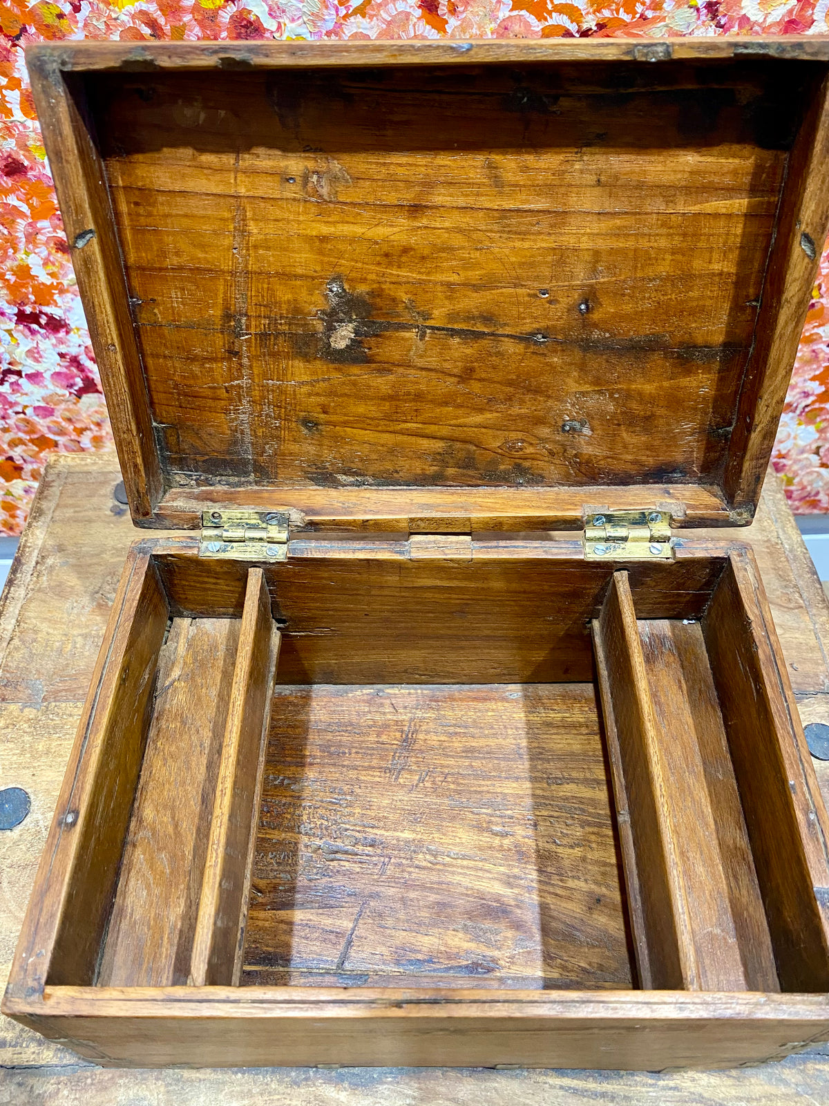 A lovely old southern Indian cash box with carved top and original brass trim, handle and hinges. Fitted with two small shelves inside. Made from teak, this would make a lovely trinket box, key box, jewellery, watch or cufflink box Circa 1880 - 1920. Measurements: length 27.5 cm  x depth 19 cm, height 15 cm.