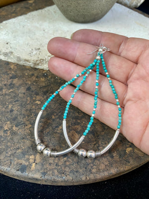 Hand crafted using tiny natural turquoise beads and 925 sterling silver. These very long earrings are unique.  Natural Arizona turquoise Sterling silver hooks and bead detailing Light and easy to wear  Measurement: total height including hook approximately 9.5 cm (3.75 in)