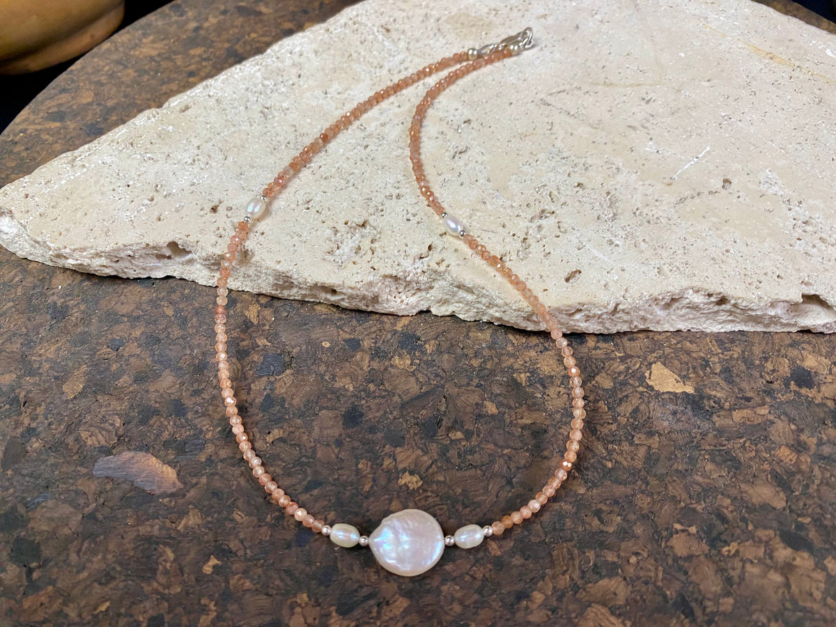 Natural clear pink/orange sunstone bead necklace is teamed with cultured pearls and sterling silver detailing. A silver lobster clasp complete the look. Length 40.5 cm