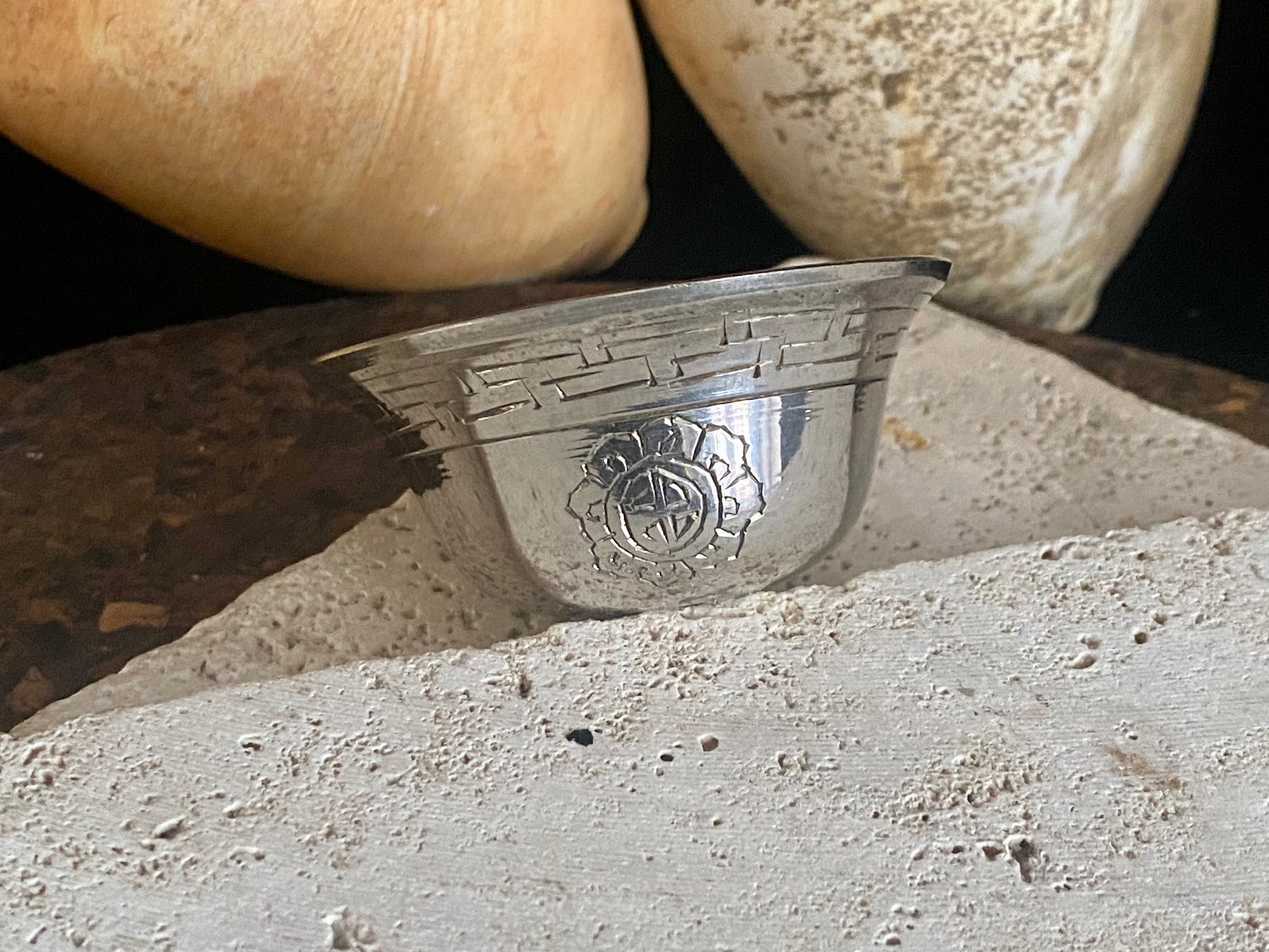 These offering bowls are metal finished with silver plate. They are decorated with repeating etched rim and flower medallions. From Nepal. These make beautiful miniature offering bowls and when filled with sand are perfect for holding incense. Measurements: 3 cm height, diameter at top 6 cm