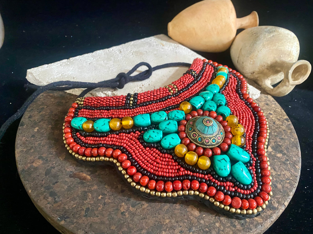 Traditional bib or pectoral beaded necklace, with a multitude of colourful ceramic and resin stones sewn onto a stiff fabric background and tied around the neck with a cord. Sikkim jewellery, India