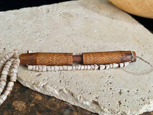 This is a vintage wood sewing needle case from northern Thailand, from the Ahka tribe. This beautiful, old and rare vintage piece is highly decorated and made from bamboo, etched, stained with red betel juice and finished with a long fringe of Jacob's tears. Length 24.5 cm with fringe, length of tube 9 cm