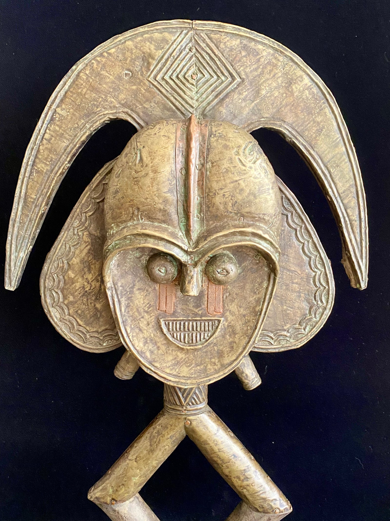Mbulu-ngulu or funerary reliquary protective figure. Kota people, Gabon, West Africa. Mid to late 20th century. Wood with copper and brass decorative overlay. Height 54 cm, width at widest point 30 cm.