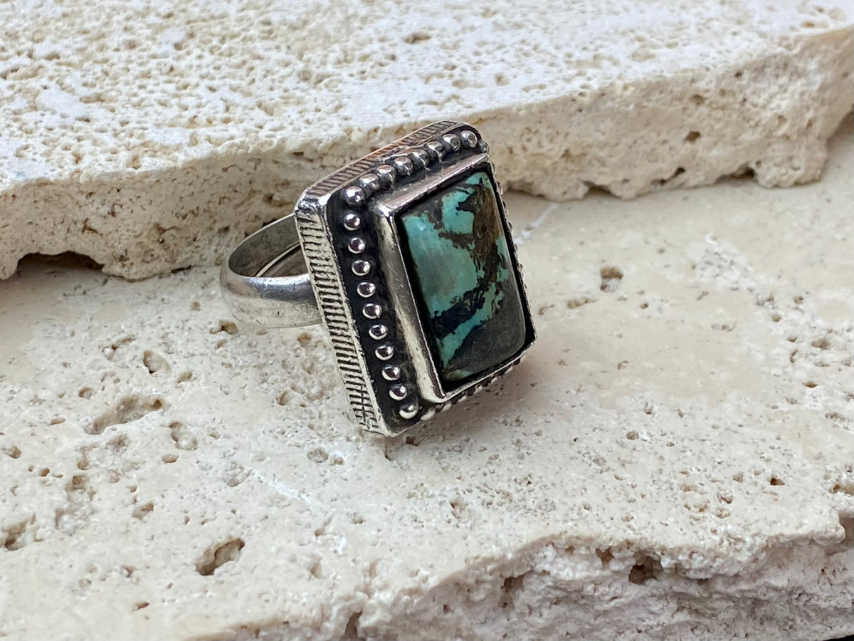 Silver tribal ring, set with a large antique Tibetan turquoise stone. This substantial heavy ring weighs almost 15 grams. Will suit either men or women. Afghanistan. Measurements: Ring face 2.2 x 2 cmInner diameter 17.5 mm | Size 7, however this is an adjustable ring that will fit any finger from size 6 to 8.
