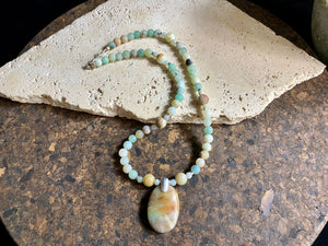 Unique necklace features matt amazonite beads highlighted with an amazonite pendant in the same shades of blue, white and pale red, mounted with a silver bail. Finished with sterling silver. Measurements: length 45.8 cm, pendant length 4 cm