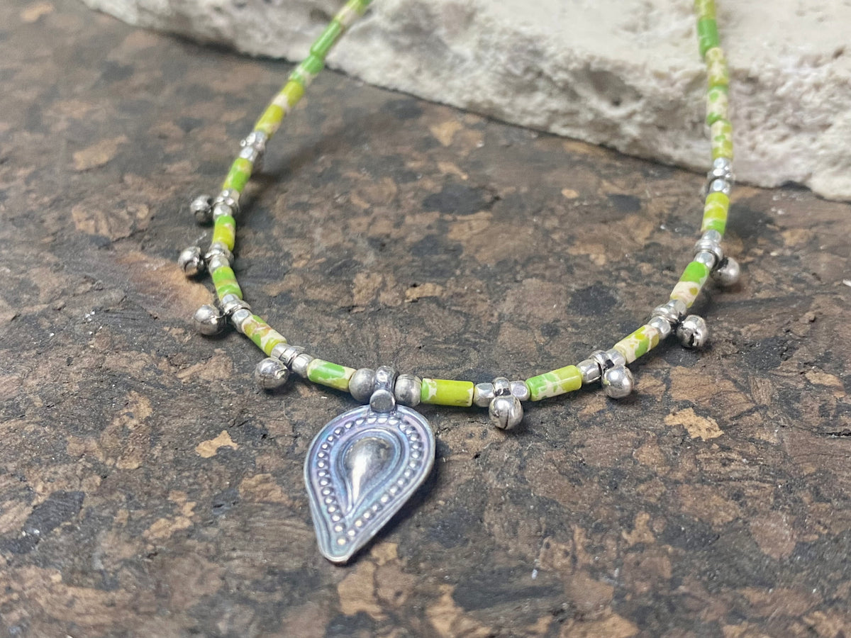 This very pretty necklace is made from tube cut imperial green jasper, highlighted with traditional handmade sterling silver Rajasthani ball beads and a tribal pendant. Finished with sterling silver findings and hook clasp. The pendant represents the shiva lingam/yoni. Length 40.5 cm