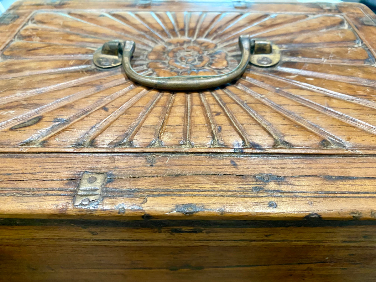 A lovely old southern Indian cash box with carved top and original brass trim, handle and hinges. Fitted with two small shelves inside. Made from teak, this would make a lovely trinket box, key box, jewellery, watch or cufflink box Circa 1880 - 1920. Measurements: length 27.5 cm x depth 19 cm, height 15 cm.