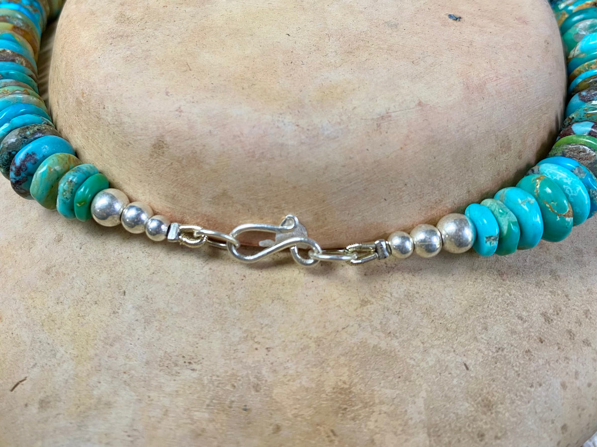 Stunning bright blue Arizona turquoise necklace featuring graduated disks of Arizona turquoise finished with sterling silver. Length 47.5 cm