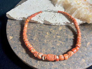 A stunning necklace of graduated antique red coral from the Himalayas, purchased in northern Thailand in 2004 and finished with a sterling silver clasp. This strand has 88 beads including a magnificent centre bead and weighs 55 grams. Length 45.5 cm