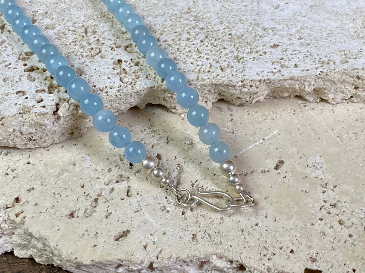 Natural aquamarine necklace featuring round aquamarine beads and a sterling silver clasp.   The aquamarines are matched a light and even blue of beautiful quality. Measurements: 47.5 cm