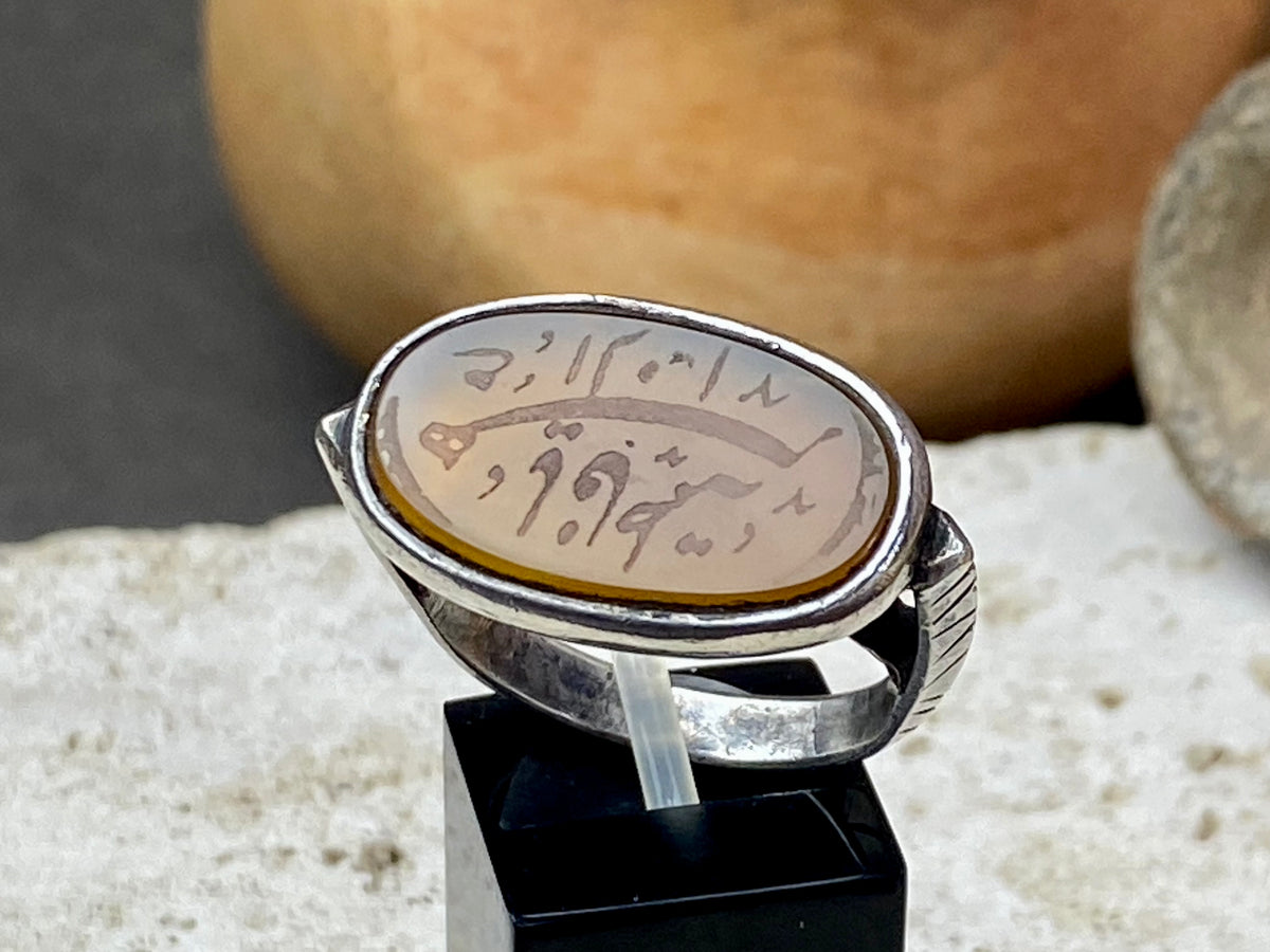 Afghani ring features an antique honey-coloured engraved carnelian prayer plaque set into a new silver band. Sits high on the finger and is a statement piece. High grade or sterling silver has been used to make the ring band. Men or women's ring. Measurements: Carnelian 2.4 x 1.4 cm, inner diameter 19.75 mm | Size 10