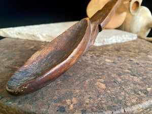 Very old wood serving spoon or ladle. Hand carved fine grained wood. From northern Ethiopia.This spoon has a lovely worn patina commensurate with its age. The spoon end is darkened from use in or near an open fire. Early 20th century. Length 44.5 cm
