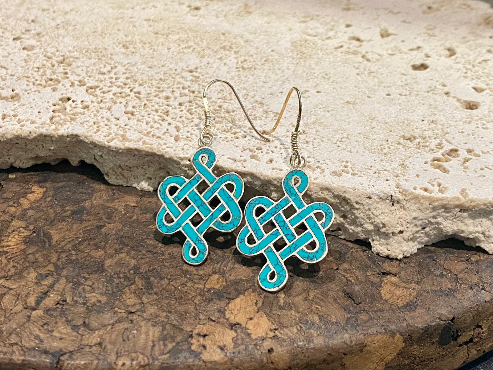 These sterling silver and turquoise earrings are the Buddhist symbol called the endless knot. They are finished with sterling silver hooks. Height 4.5 cm including hook.