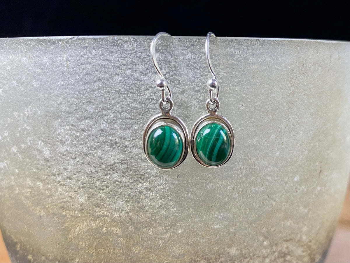 Simply elegant oval earrings with a small shadow box bezel to show off the beauty of the natural cabochon gemstones. Sterling silver hooks complete the look. Our earrings are open-backed to allow the light of the stones to show through. Length including hook 2.5 cm