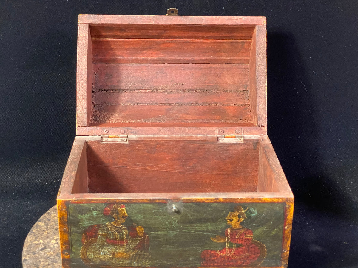 A lovely old painted Indian chest with domed top in the shape of a treasure chest. Painted on all sides with images of Indian lords and ladies. Made from teak. This would make a lovely trinket box, key box, jewellery, watch or cufflink box. Circa 1940. Measurements: length 24 cm x depth 15.5 cm, height 16 cm
