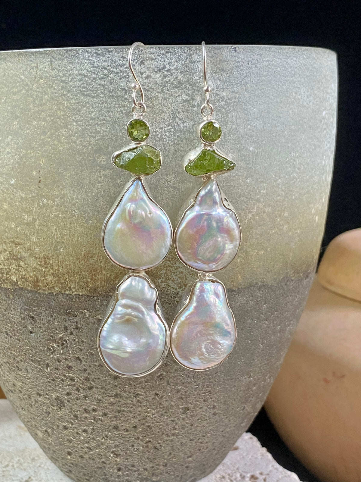 Very long earrings featuring cultured baroque pearls and peridot stones. These statement earrings are set in sterling silver, with sterling silver shepherd hooks. 8 cm length including hooks, width approximately 1.8 cm, depth 0.5 cm