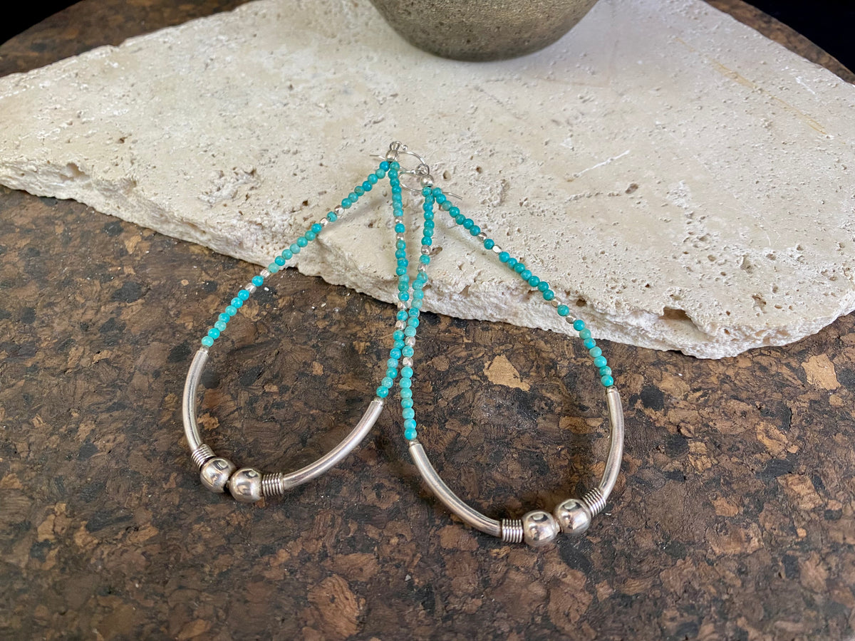 Hand crafted using tiny natural turquoise beads and 925 sterling silver. These very long earrings are unique.  Natural Arizona turquoise Sterling silver hooks and bead detailing Light and easy to wear  Measurement: total height including hook approximately 9.5 cm (3.75 in)