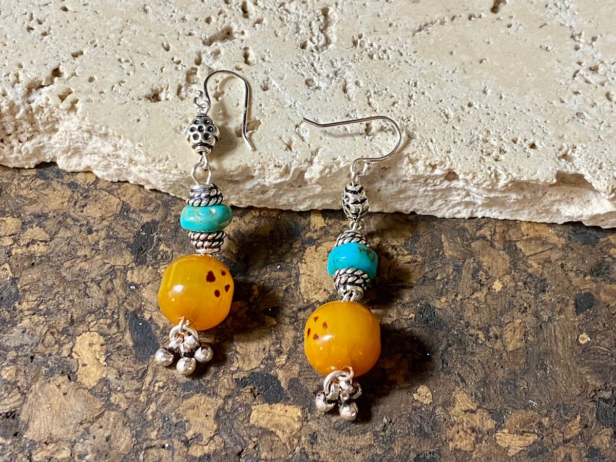 These exotic earrings were created from vintage copal amber beads topped with Arizona turquoise and handmade sterling silver beads, finished with sterling silver hooks.These are a one-off earring design that are very light and easy to wear. Length 5.8 cm including hook