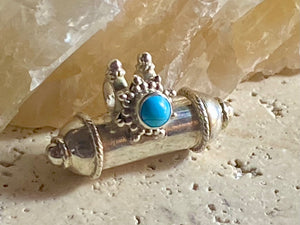 These lovely box pendants open at one end and have plenty of room to place items inside. Two bails complete the look. Sterling silver, finished with a turquoise stone.  Two sizes to choose from