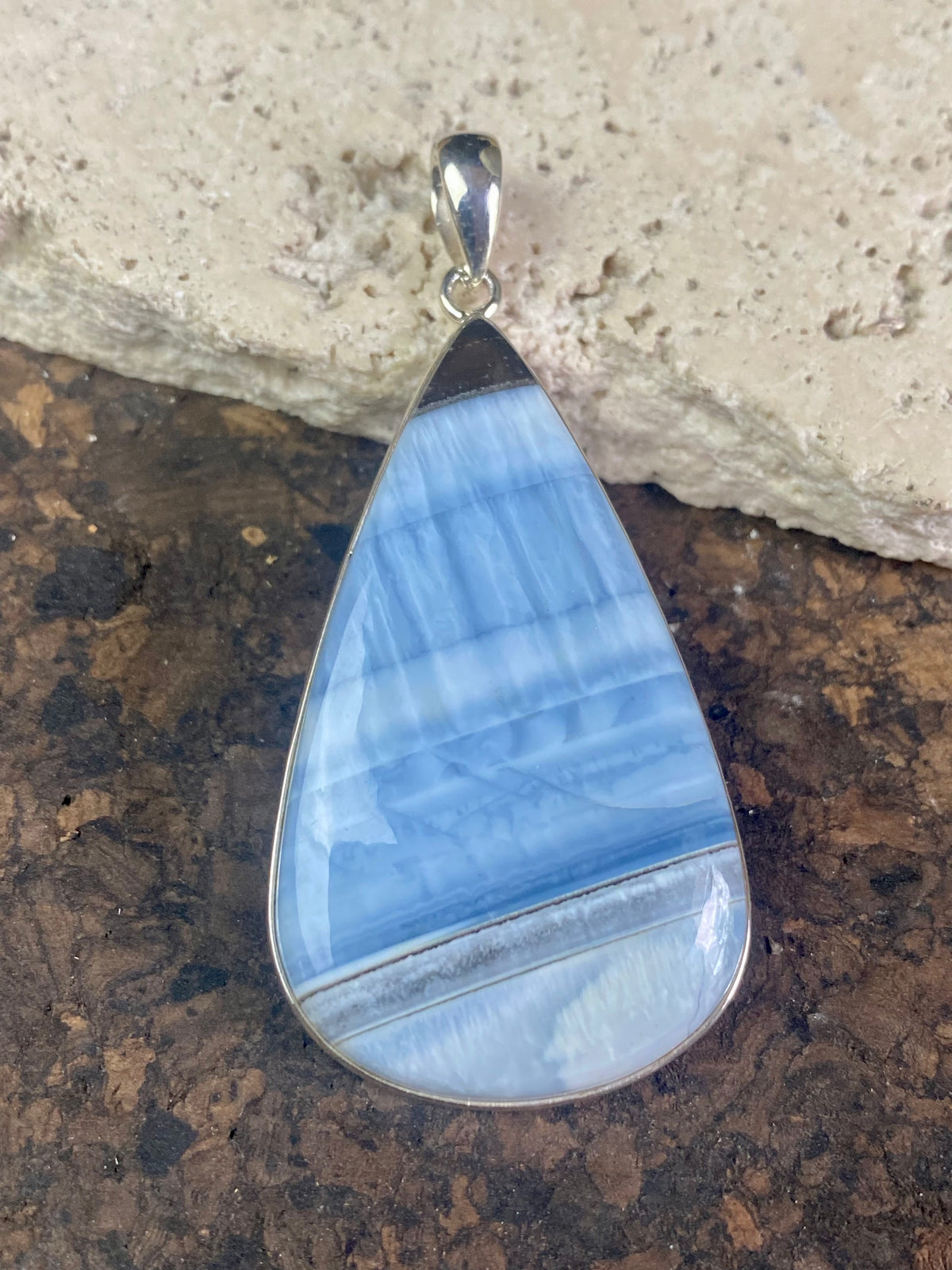 Natural banded blue opal pendants. Set off by sterling silver bezels, topped by generous sized bails large enough to accommodate a thick chain or cord. If you're looking for something a little bit different, this is statement jewellery at its finest.