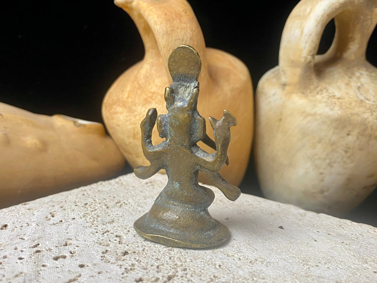 This exquisite miniature Ganesh statue features fine, elegant features, a face rubbed through many years of worship and a high tribal headdress typical of the eastern states of India. Early 20th century, India, bronze alloy.  Measurements: height 6.5 cm, width 3.2 cm, depth 2.5 cm