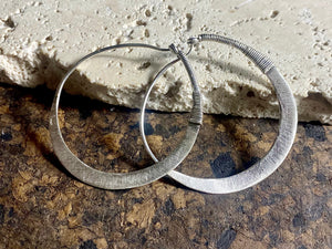 Beautiful hand beaten sterling silver hoops with wrapped silver wire detailing.  Waziri, from Afghanistan.  Measurements: outside diameter of hoop approximately 4.6 cm