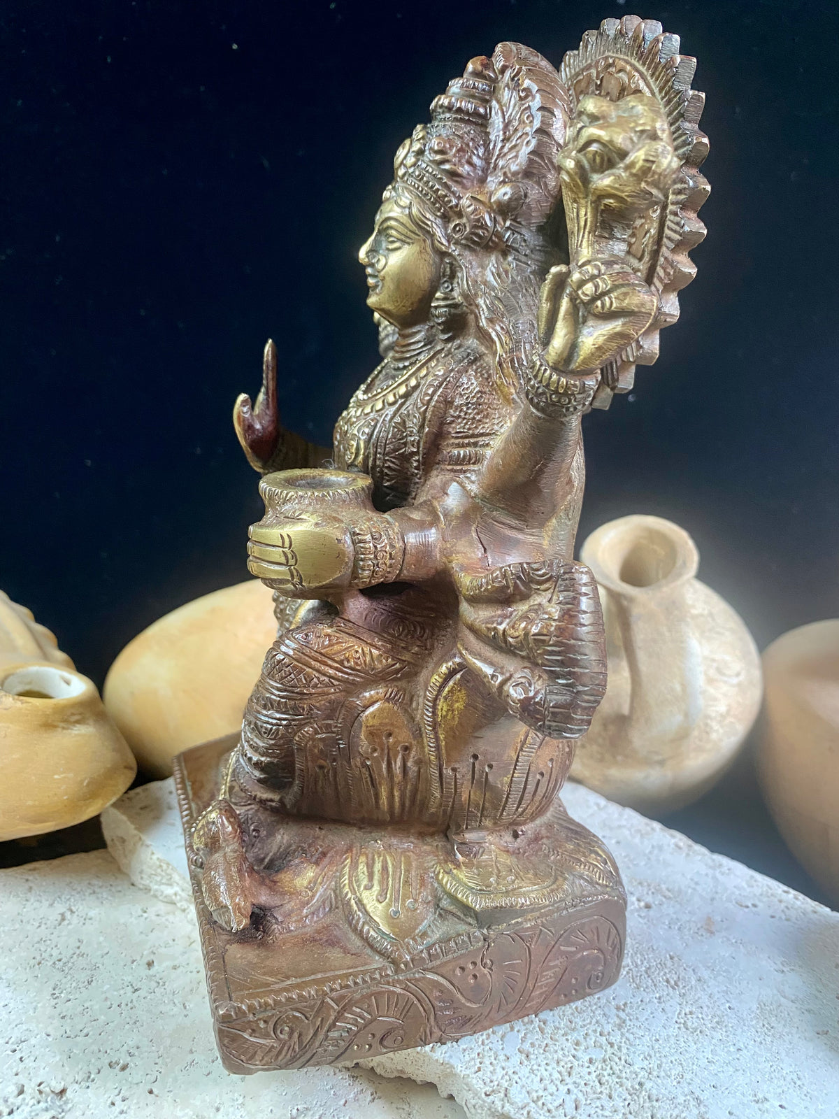 A statue of the goddess Laxmi (or Lakshmi), Hindu goddess of wealth and prosperity. Cast from solid brass, her features are exquisitely detailed, while her face, hands and feet are polished. Her right hand is raised in the gesture of protection and her left hand holds a pot symbolising abundance. Measurements: 19.8 cm height, width12 cm, depth 8.3 cm