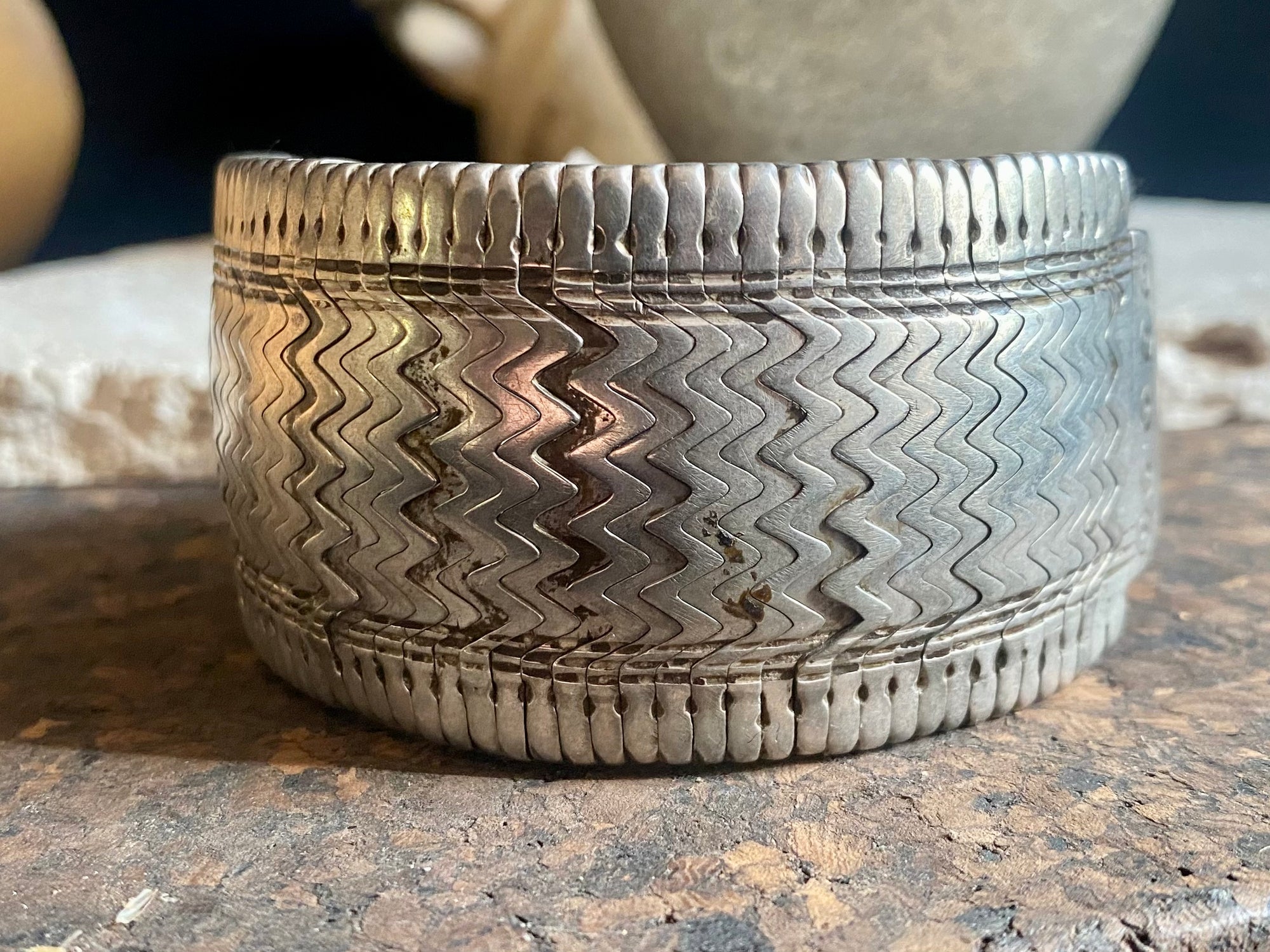 Antique bazuband bracelet, made up of interlocking components threaded onto cord with toggle closure. Early 20th century or earlier, high grade silver. This is an excellent example, and is a very collectible yet wearable piece of jewellery. Weight 94 grams. Inside circumference 21 cm. Height 4 cm, length 17 cm