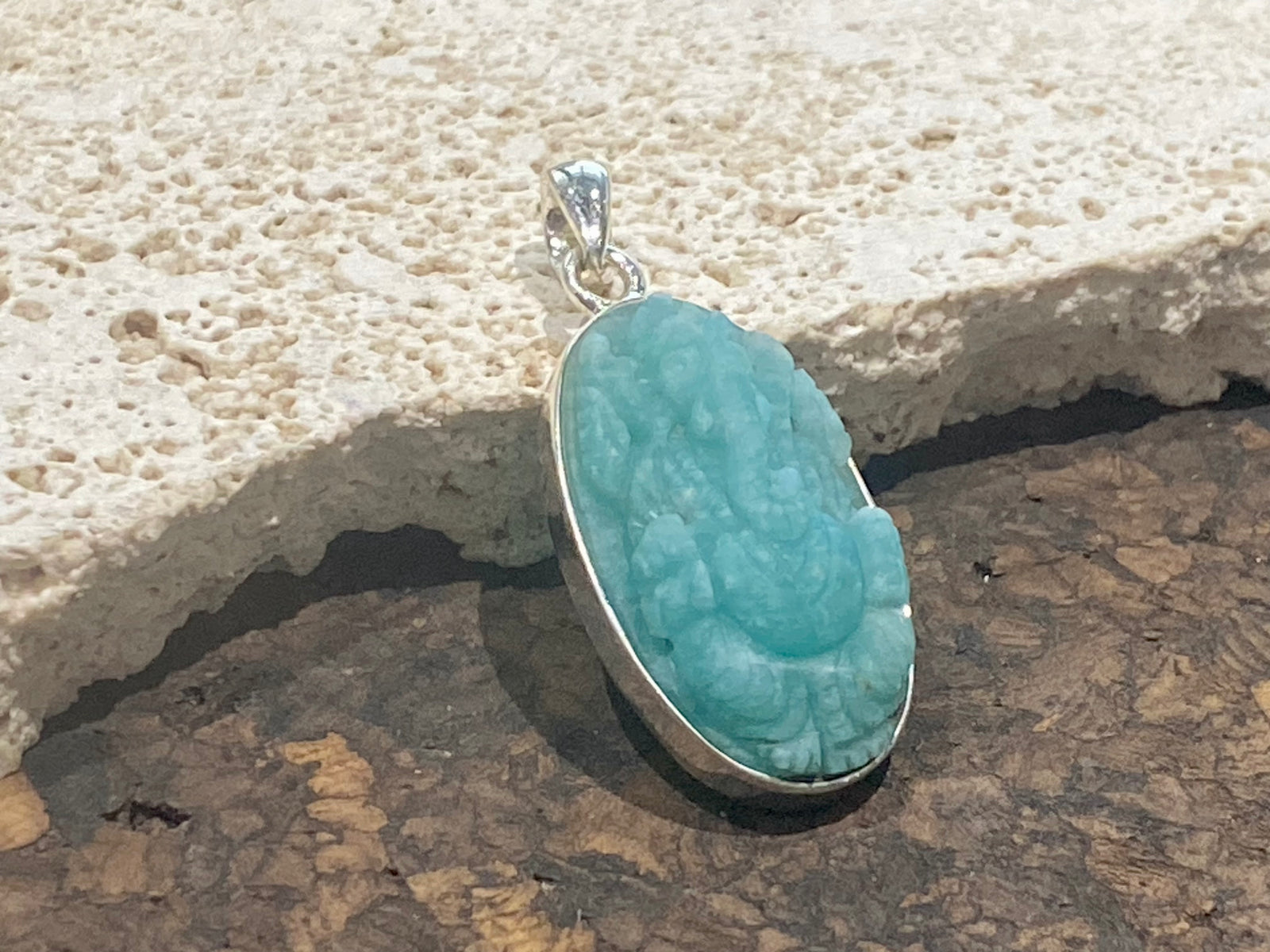 Hand carved gem quality translucent amazonite carved as n image of Ganesh. height 4.1 cm including bail. 