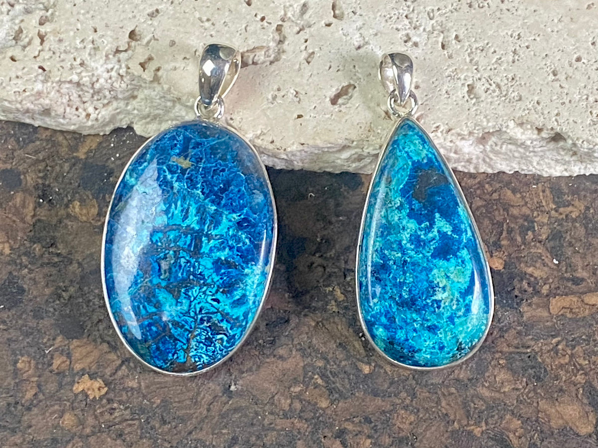 Unusual and striking azurite pendants. Set off by sterling silver bezels, topped by generous sized bails large enough to accommodate a thick chain or cord. If you're looking for something a little bit different, these pendants are stunning.