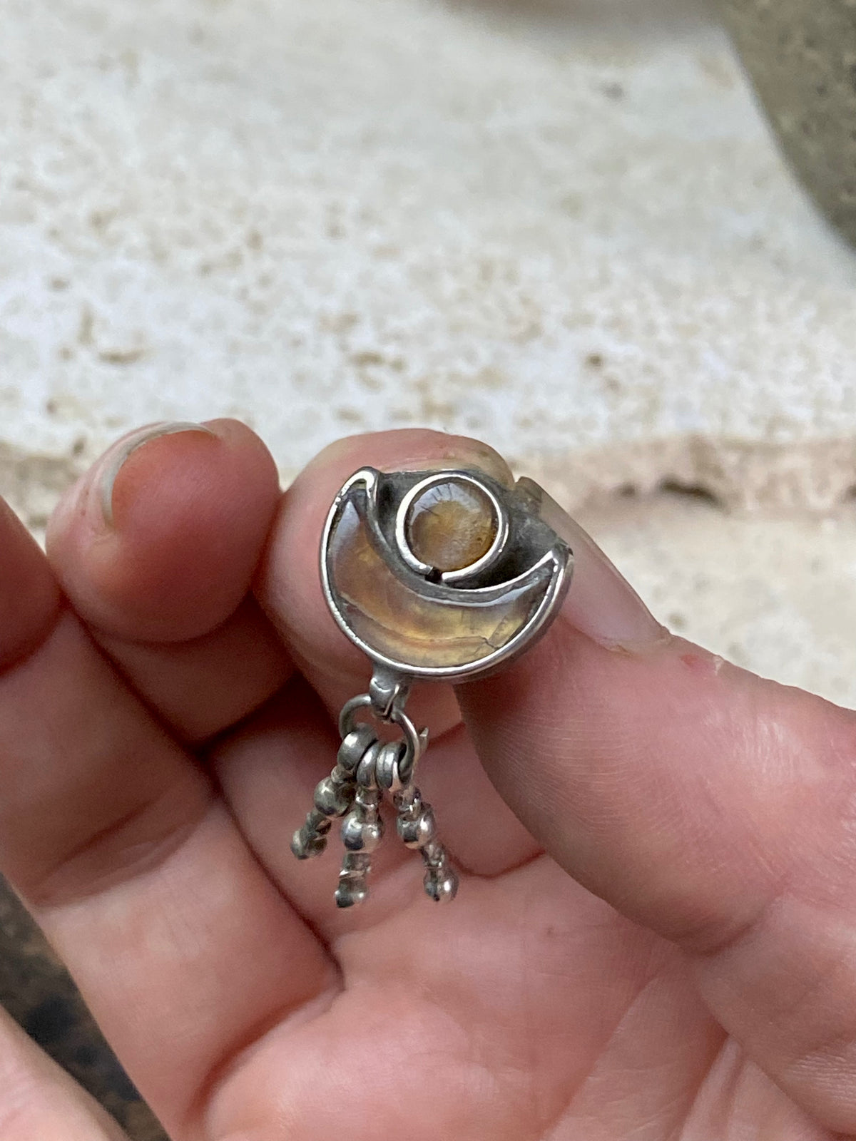 Antique amulet representing Shiva through its depiction of the upturned crescent moon. In the style of Kundan jewellery, glass over a coating of gold or copper. 19th century in age or older. High grade silver, northern India. This is a beautiful, old pendant. Height 3.2 cm, height of pendant 1.4 cm, width 1.5 cm