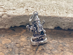 Sterling silver pendant featuring Lord Ganesha portrayed in 3D, this heavy silver charm pendant can be viewed in 3 dimensions, with his back as complete and as detailed as his front. A generous bail allows this pendant to be worn on a large chain or cord. he can even sit upright as the smallest of ganesh statues. This is a unisex pendant or statue. Sterling silver. Measurements: 3 cm height including bail