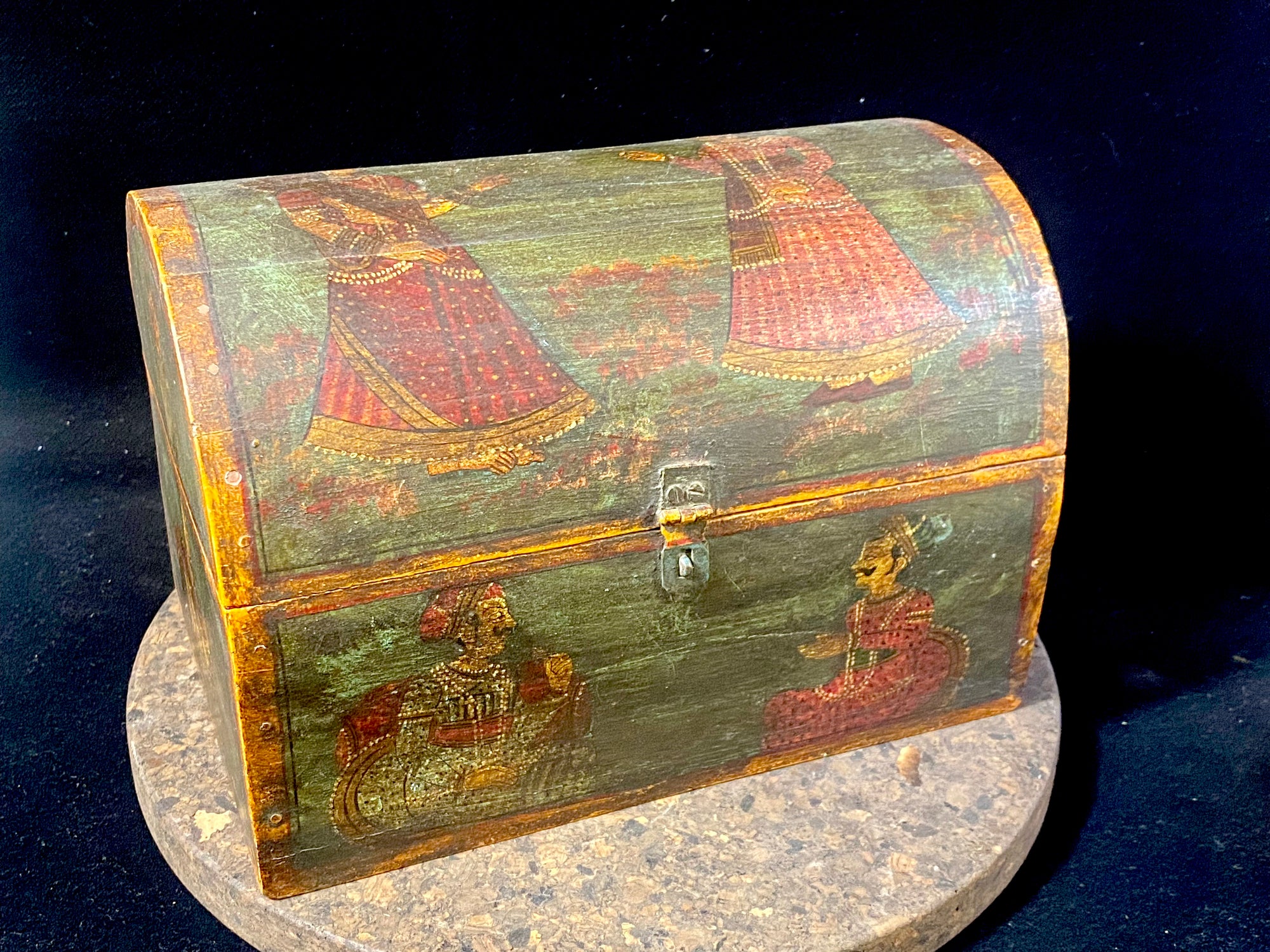 A lovely old painted Indian chest with domed top in the shape of a treasure chest. Painted on all sides with images of Indian lords and ladies. Made from teak. This would make a lovely trinket box, key box, jewellery, watch or cufflink box. Circa 1940. Measurements: length 24 cm x depth 15.5 cm, height 16 cm