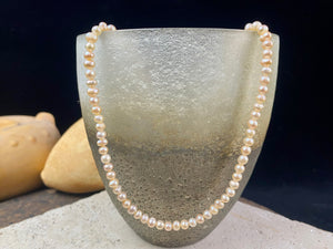 A simple pearl choker necklace, featuring champagne coloured off-round pearls, finished with sterling silver findings and clasp.  These are quality cultured freshwater pearls with a beautiful sheen and thick nacre finish.   Measurements: length 39.5 cm including clasp. Pearls are 4 mm diameter