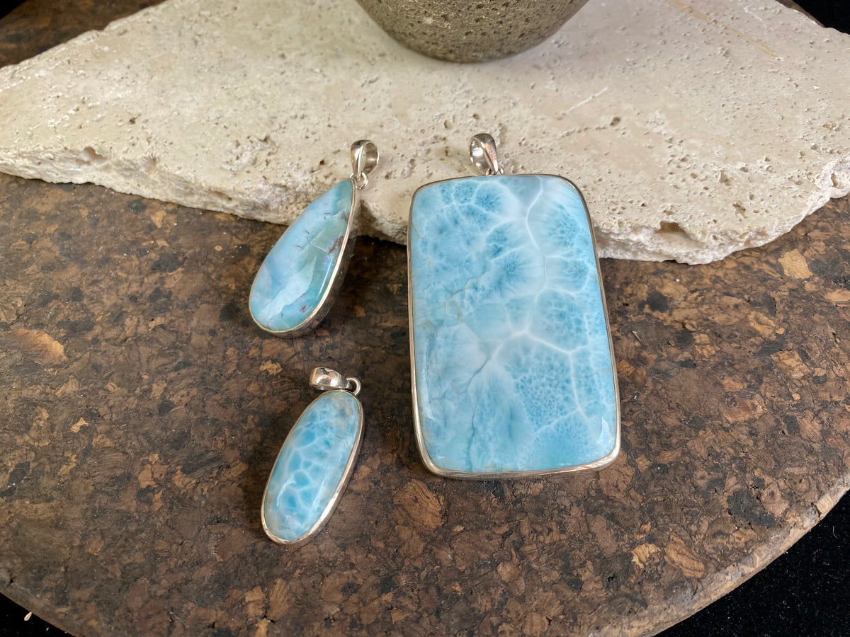 Larimar stone pendants set in sterling silver. Each pendant is unique, cut and mounted to showcase the beauty of the individual stones.