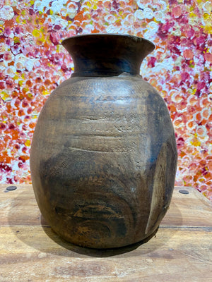 These gracefully shaped pots were used to store lassi, oil, milk, water and grain. This large example comes from northern India and is carved from solid hardwood, in this case most likely teak. Mid 20th century or earlier. slight decoration around the neck and mouth. Repair to the base. Measurements: diameter 22 cm, height 28 cm