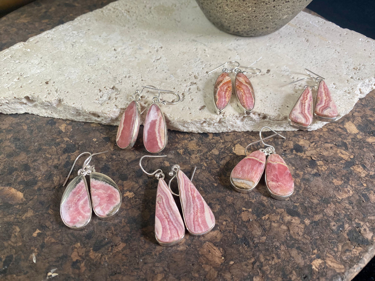 The most beautiful rhodochrosite we've ever seen. Every piece tells a story, and all earring pairs feature perfectly matched stones set in sterling silver bezels. Finished with sterling silver hooks.