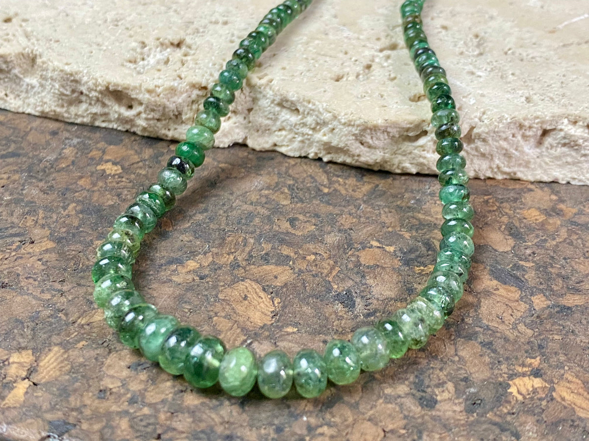 A classic necklace of graduated, matched natural emeralds featuring sterling silver findings and hook clasp. 70 carats of emeralds, length 45.5, bead size 2 mm - 6 mm