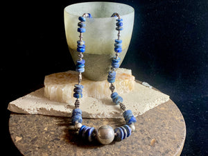 Tribal lapis lazuli and silver necklace, crafted from antique unpolished graduated Afghani lapis lazuli and handmade, vintage and antique tribal silver beads. This stunning, long necklace is finished with a sterling silver clasp and weighs 170 g. Measurements: 68 cm in length