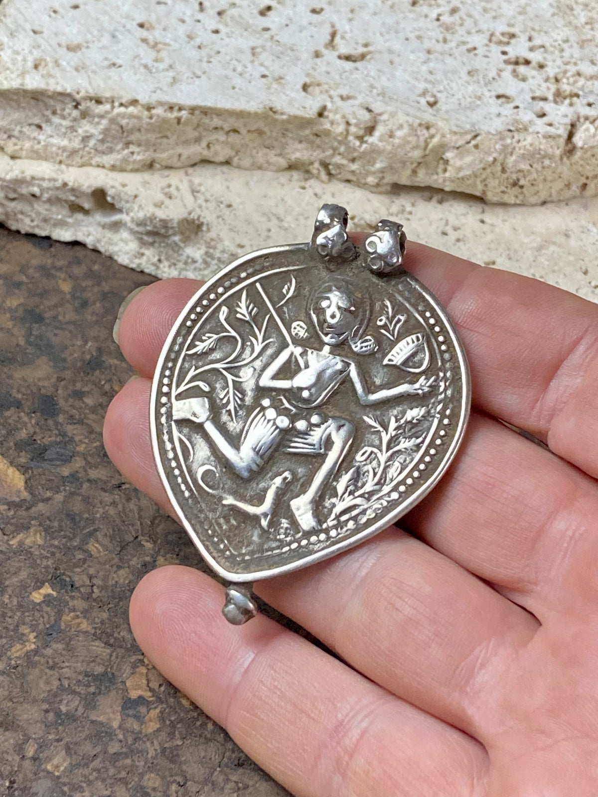 Leaf shaped amulet depicting Shiva in his form as Bheru , from the Bhil people of northern India. This amulet dates to the early 20th century or late 19th century and has its original double bail in place. From northern India. Very high grade silver.  Measurements: total height 5.8 cm including bail, width 4.2 cm at widest point.