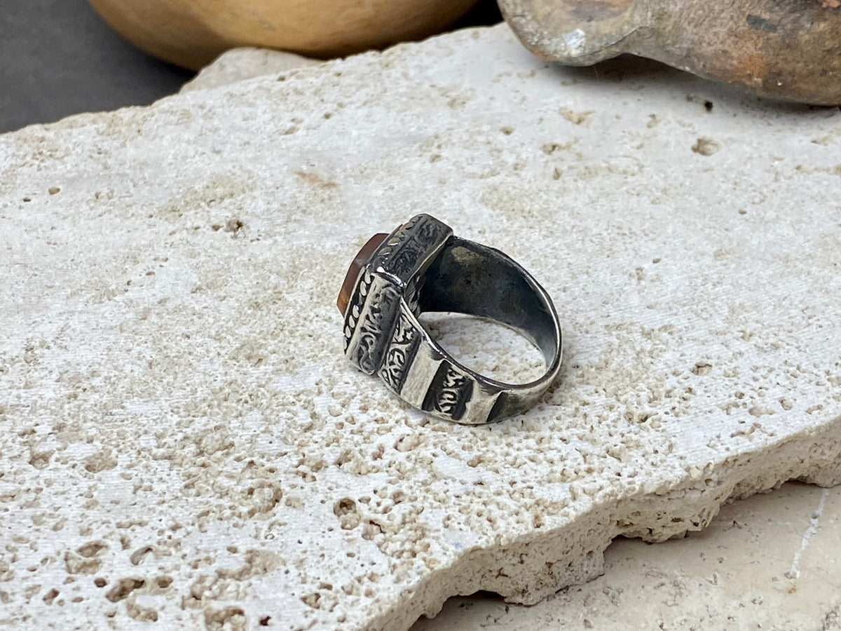 An elegant ring featuring a beautiful dark carnelian stone. The stone shows some wear commensurate with its age. Afghanistan, early to mid 20th century. Can be worn by either men or women. Measurements: Ring face 1.6 x 1.3 cm, inner diameter 18.5 mm | Size 8.5 | No 19