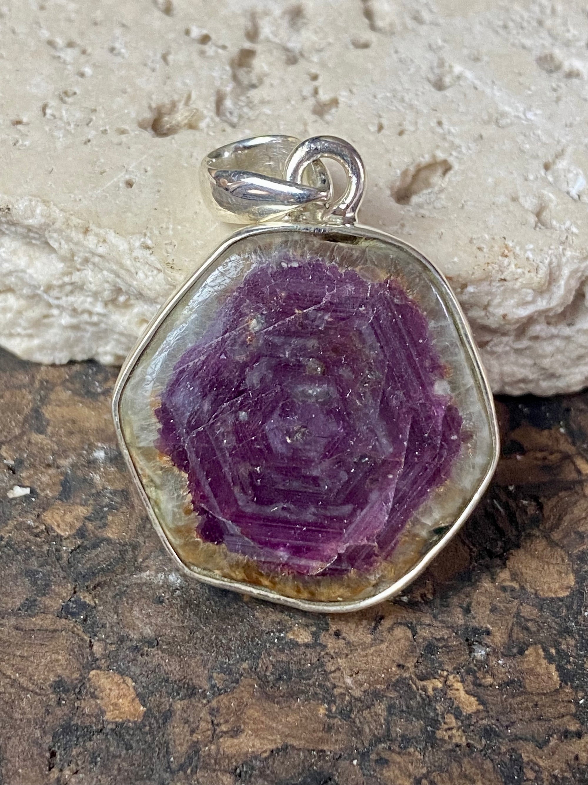 Trapiche ruby pendant with the very desirable hexagonal growth pattern, surrounded by a border of natural quartz and set in sterling silver. Height including bail 3.3 cm, width 2.2 cm