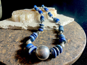 Tribal lapis lazuli and silver necklace, crafted from antique unpolished graduated Afghani lapis lazuli and handmade, vintage and antique tribal silver beads. This stunning, long necklace is finished with a sterling silver clasp and weighs 170 g. Measurements: 68 cm in length