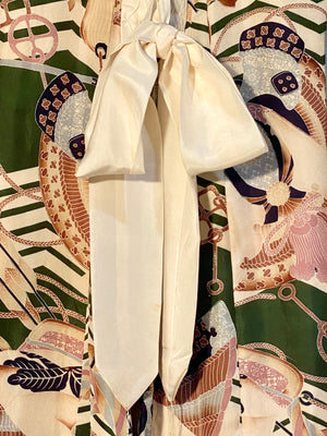 Small, hand sewn child's kimono suitable for either sex. A tasteful design features greens, tans, navy, lilac and pale blue colours in an abstracted design reminiscent of its era. Padded and lined. Hand stitched silk ties with fine thread tassel detailing. No damage, excellent condition. Circa 1950's.