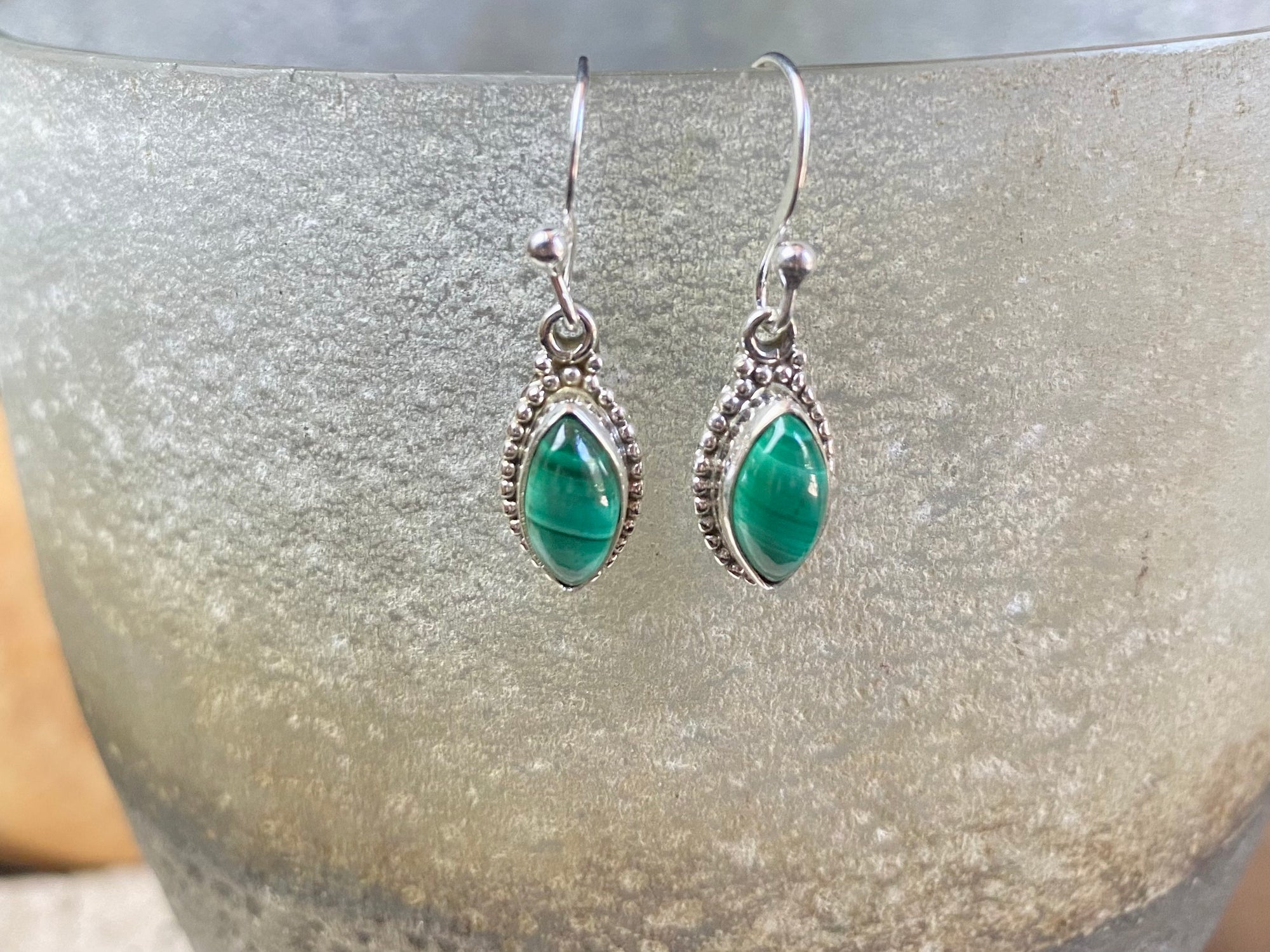 Simply elegant leaf shaped earrings with a beautifully detailed bezel to show off the natural beauty of the cabochon stones. Sterling silver hooks complete the look. Our earrings are open-backed to allow natural light to show through. Length including hook 2.7 cm