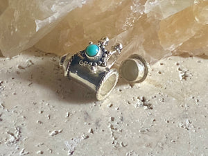 These lovely box pendants open at one end and have plenty of room to place items inside. Two bails complete the look. Sterling silver, finished with a turquoise stone.  Two sizes to choose from